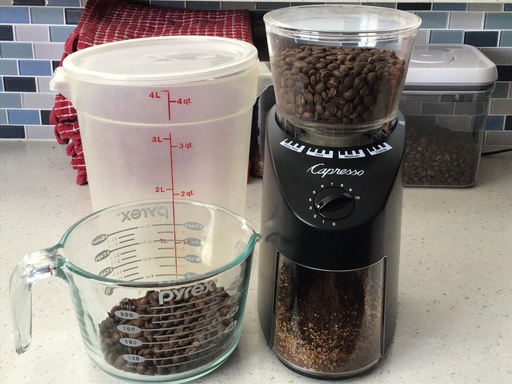 Coffee, grinder, measuring cup, and container